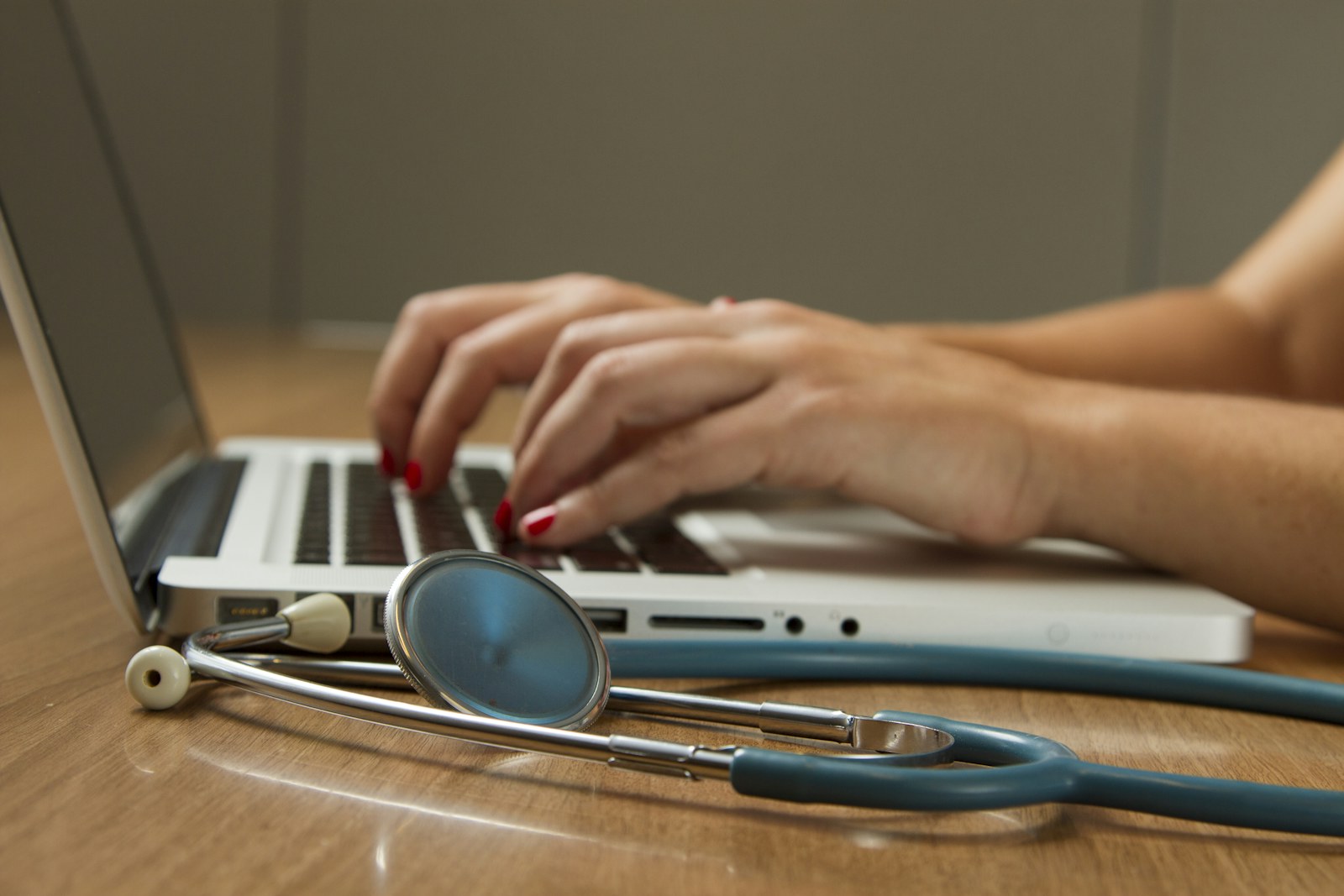 Healthcare professional learning with a laptop and stethoscope